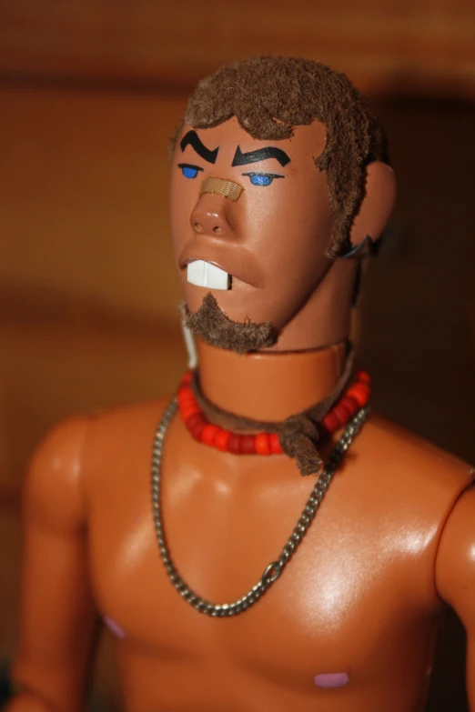 this toy figure has two strings, , and a necklace on