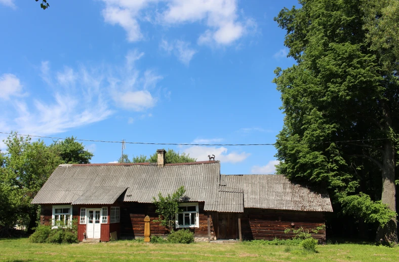 a small house is located in the green grass