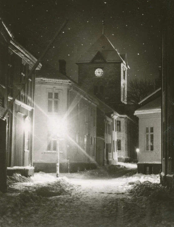 a light shines brightly from behind an old, dilapidated house