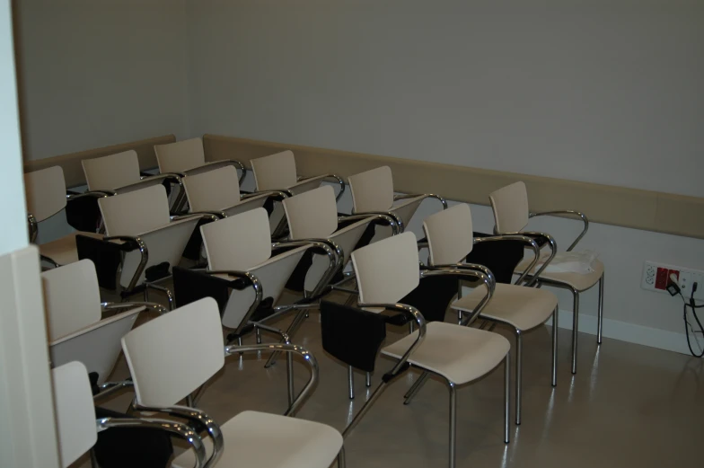 a large room with several chairs that have metal arms