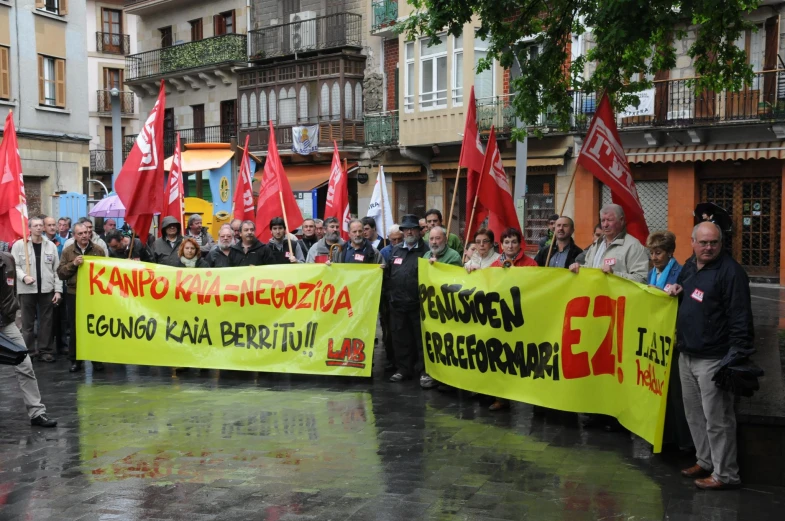 a demonstration with protesters holding large yellow banners