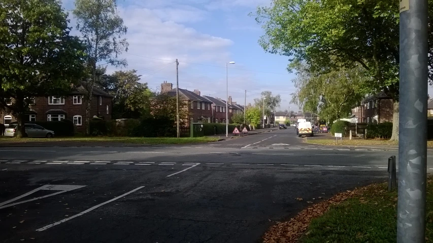 there is a street with trees along side of the road