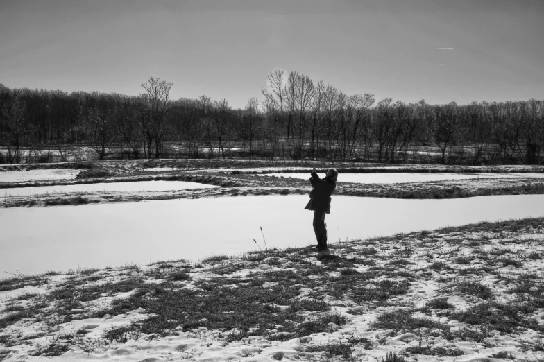 the man is walking on the snowy bank