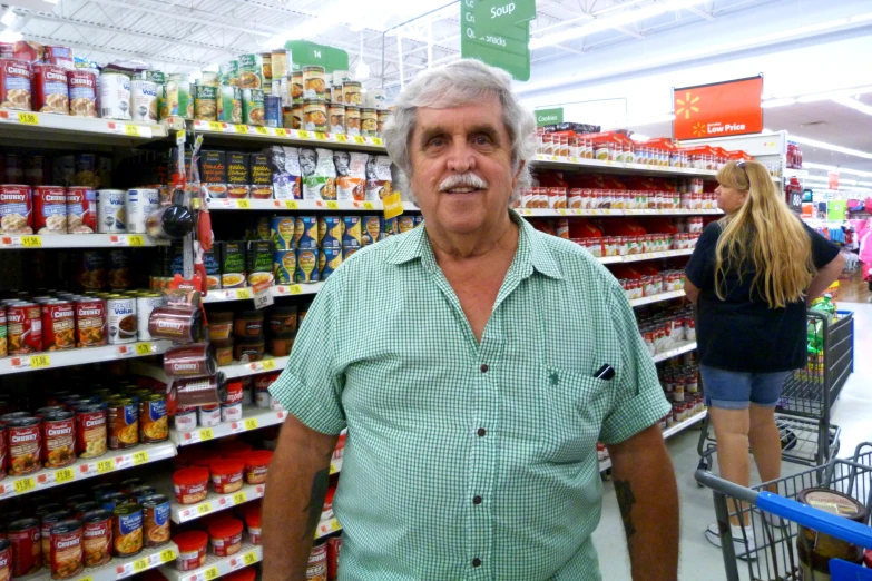 the man is standing in front of his display of spices