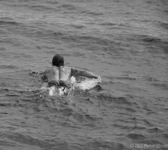 a young man is riding his surf board in the ocean