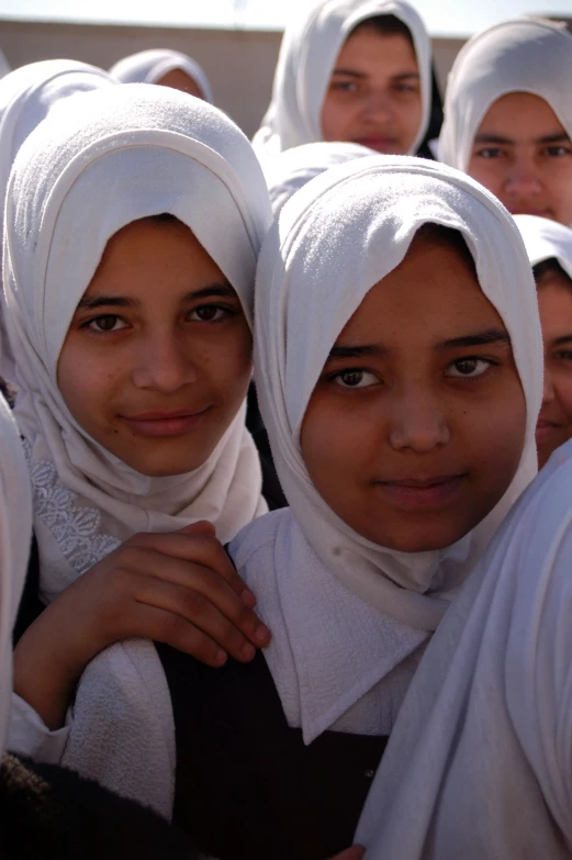 a group of women are dressed in headscarves