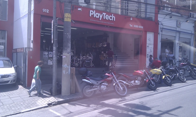 a motorcycle shop filled with motorcycles parked on the street