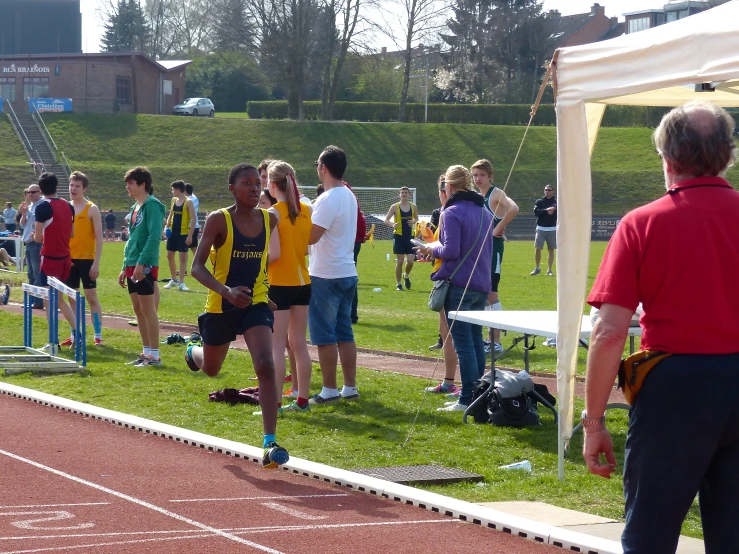 a group of young people on a track waiting for the start of the race
