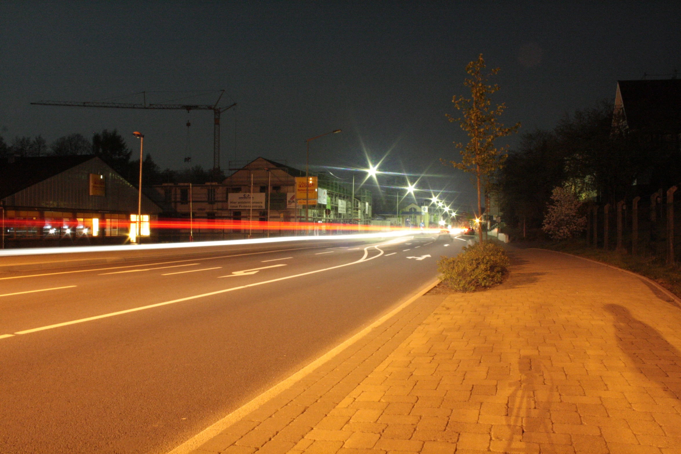 some street lights on a street by a building