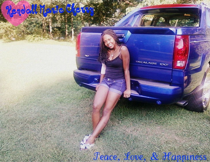 a girl sitting on the back of a truck