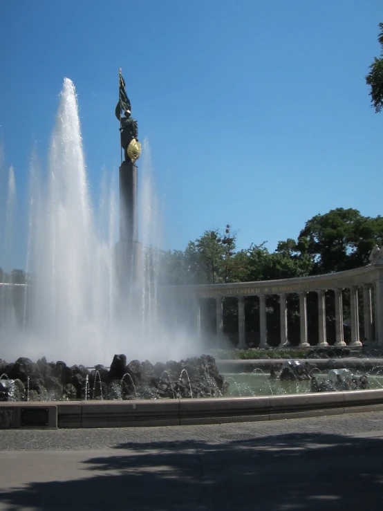 a small fountain with a man on top of it