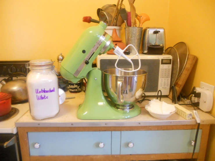 a kitchen area with various appliances on top of it