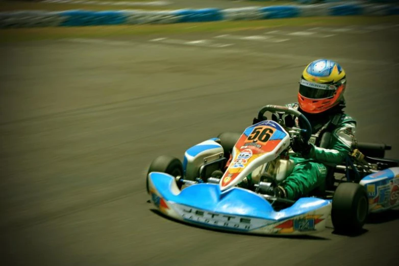a person on a small race car riding down a track