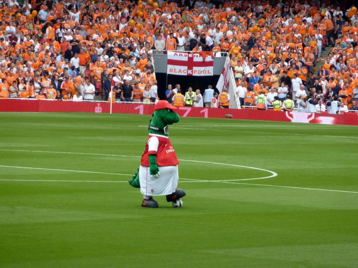 a mascot stands on the field at an orioles game