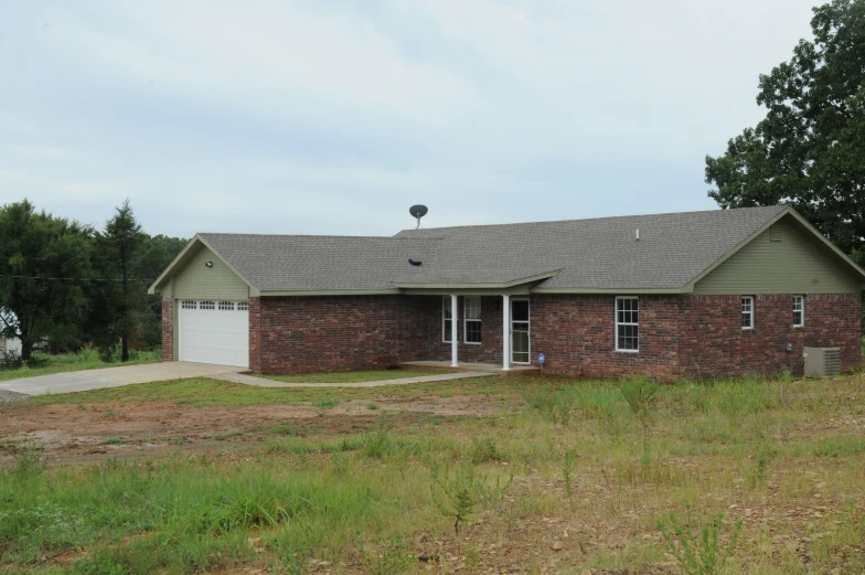 an older home sits in a grassy field