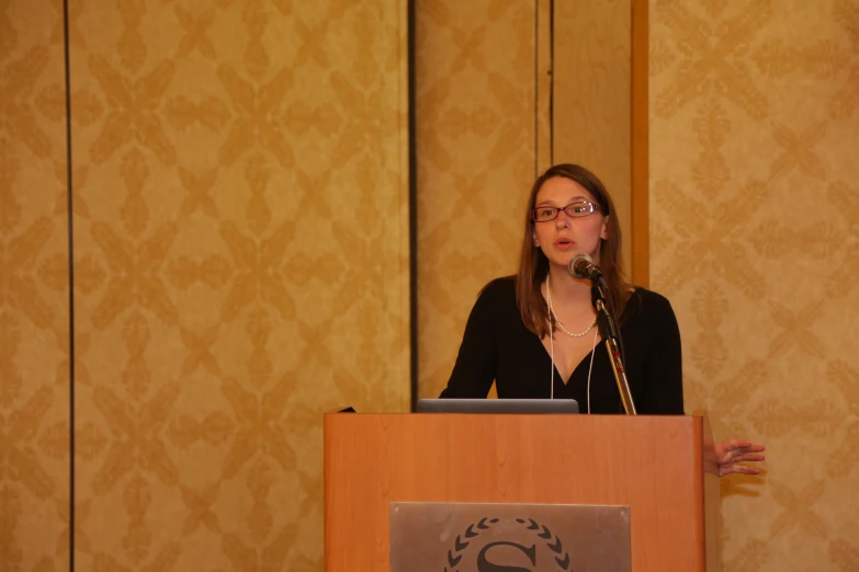 a woman in black shirt giving a speech