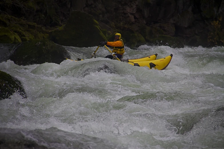 the man is using his kayak to stay on top of the rapids