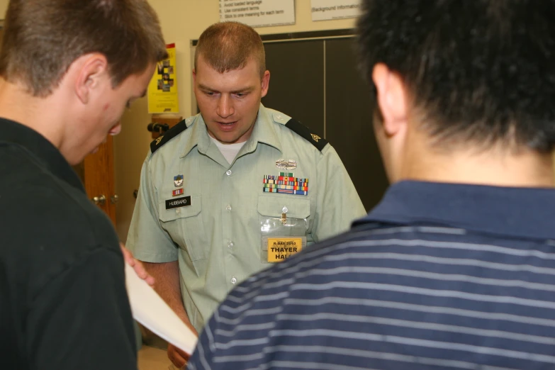 two men wearing military uniform talking to one another