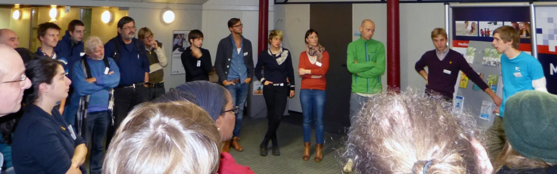 a group of people listening to speakers