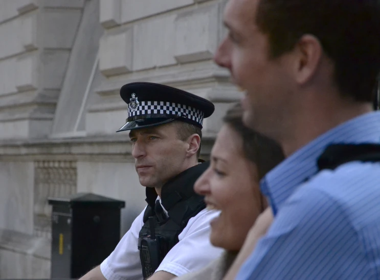 a police officer standing next to two other people