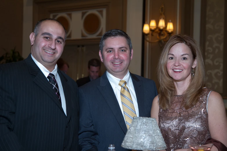 three people pose for the camera as they are dressed up