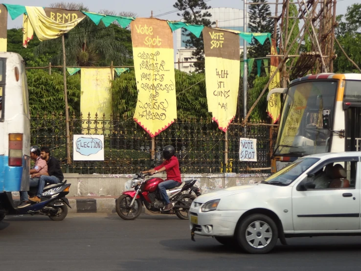 some motor bikes and some cars and people on the road