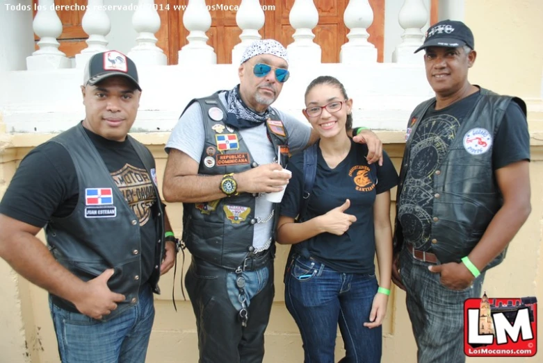 a man and three women are posing for a picture