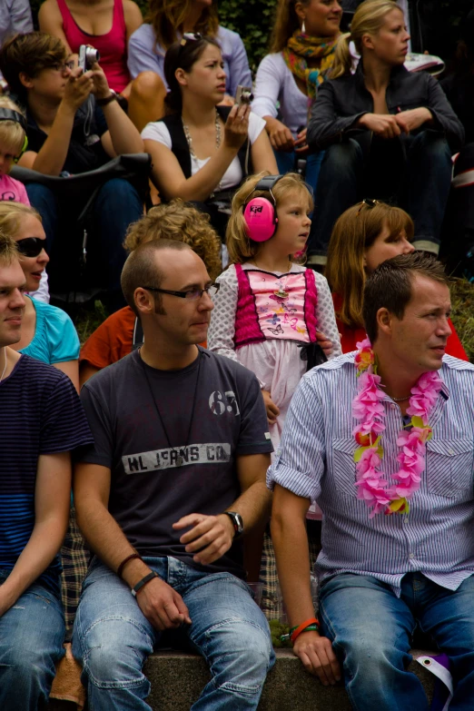 a group of people sitting next to each other in front of a crowd