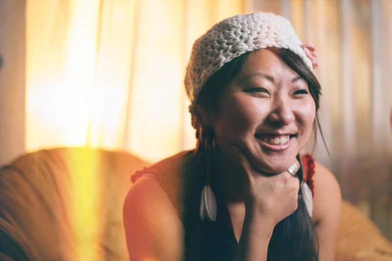 a girl in a white headband and smiling