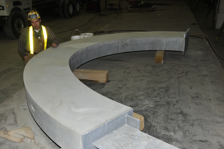 a man standing by a very large curved counter