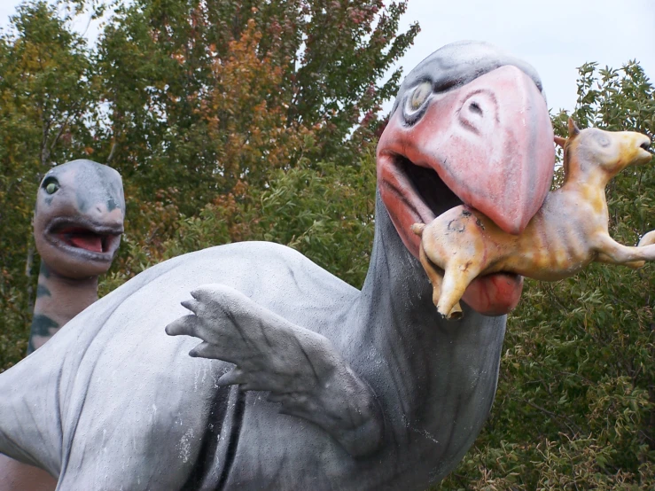 a close - up of a statue with two dinosaurs