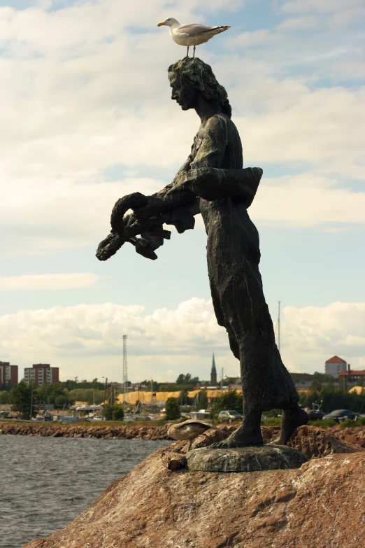 a statue with bird perched on it sitting on top of the other side