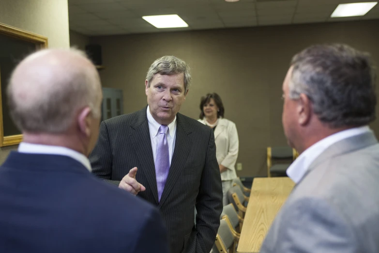 people at a meeting with one person talking