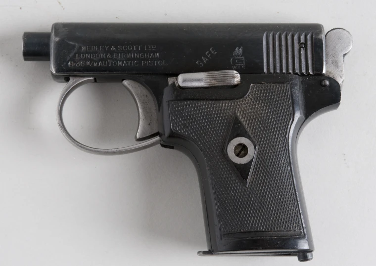 an old model colt pistol against a white background