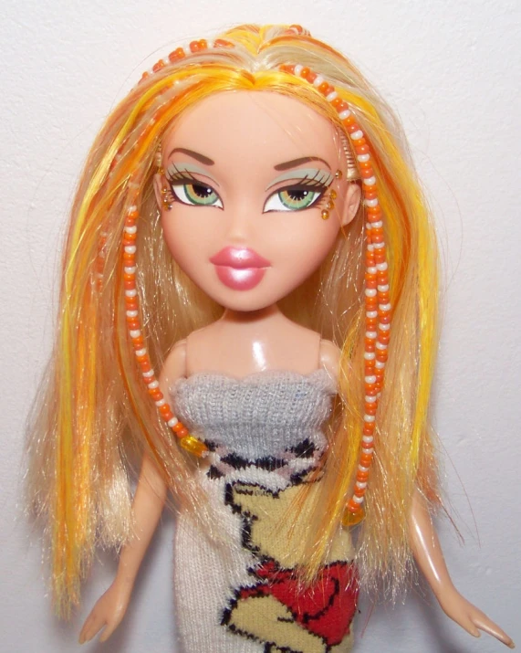 a doll in a dress with yellow hair