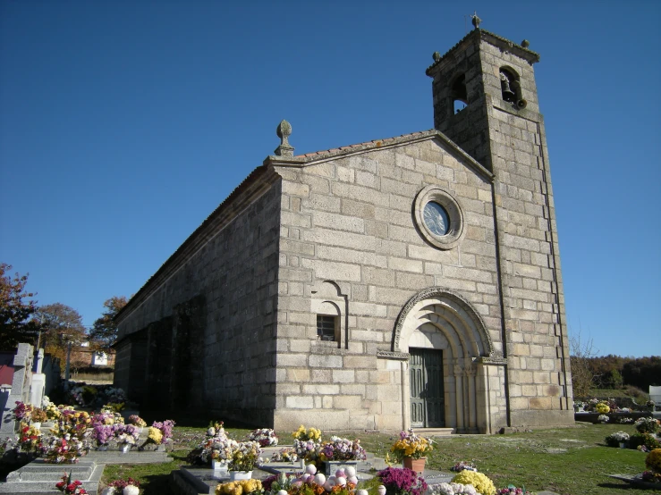 a church has flowers and candles at the front