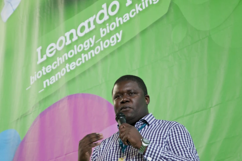 man in shirt giving a speech at an event