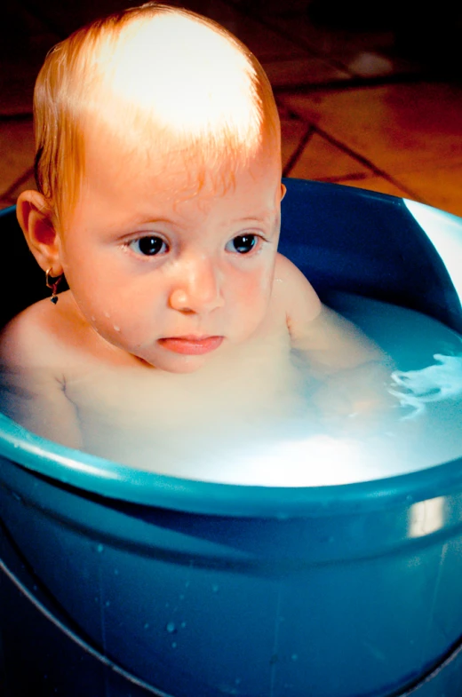 a baby in the bathtub looking up to the sky