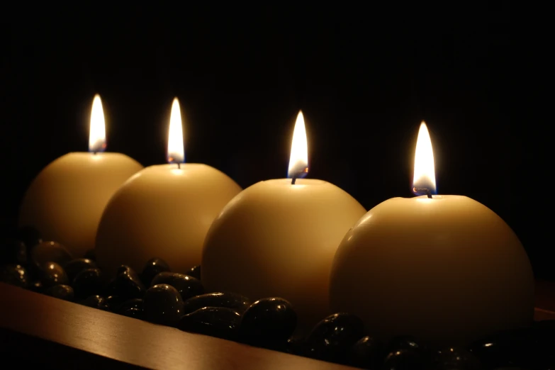 five candles are arranged next to each other on a counter