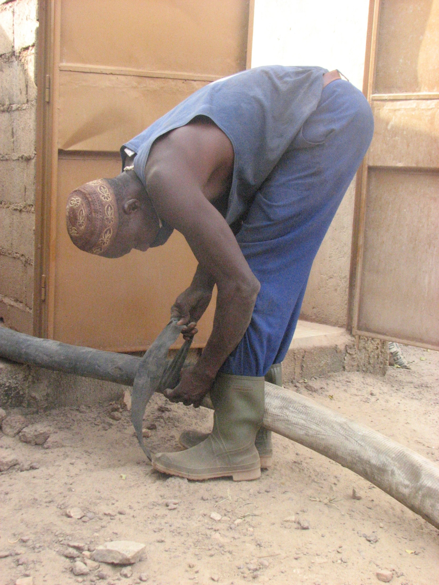 a man is bending over working with his tools