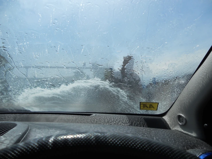 a person is surfing in the ocean through the windshield