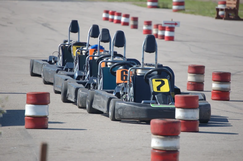 several go kart race with multiple carts racing behind them