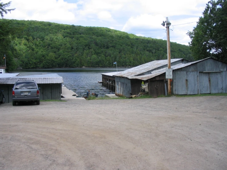 two old wooden shacks by the water