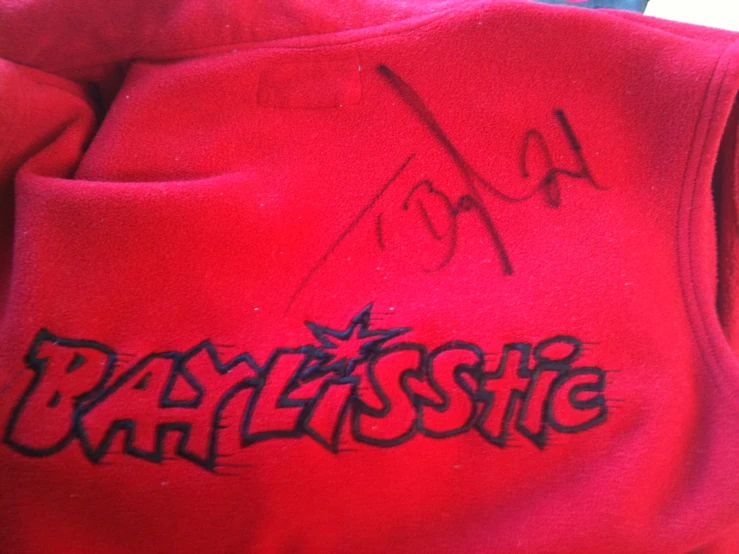 graffiti on a red sweat shirt in a store