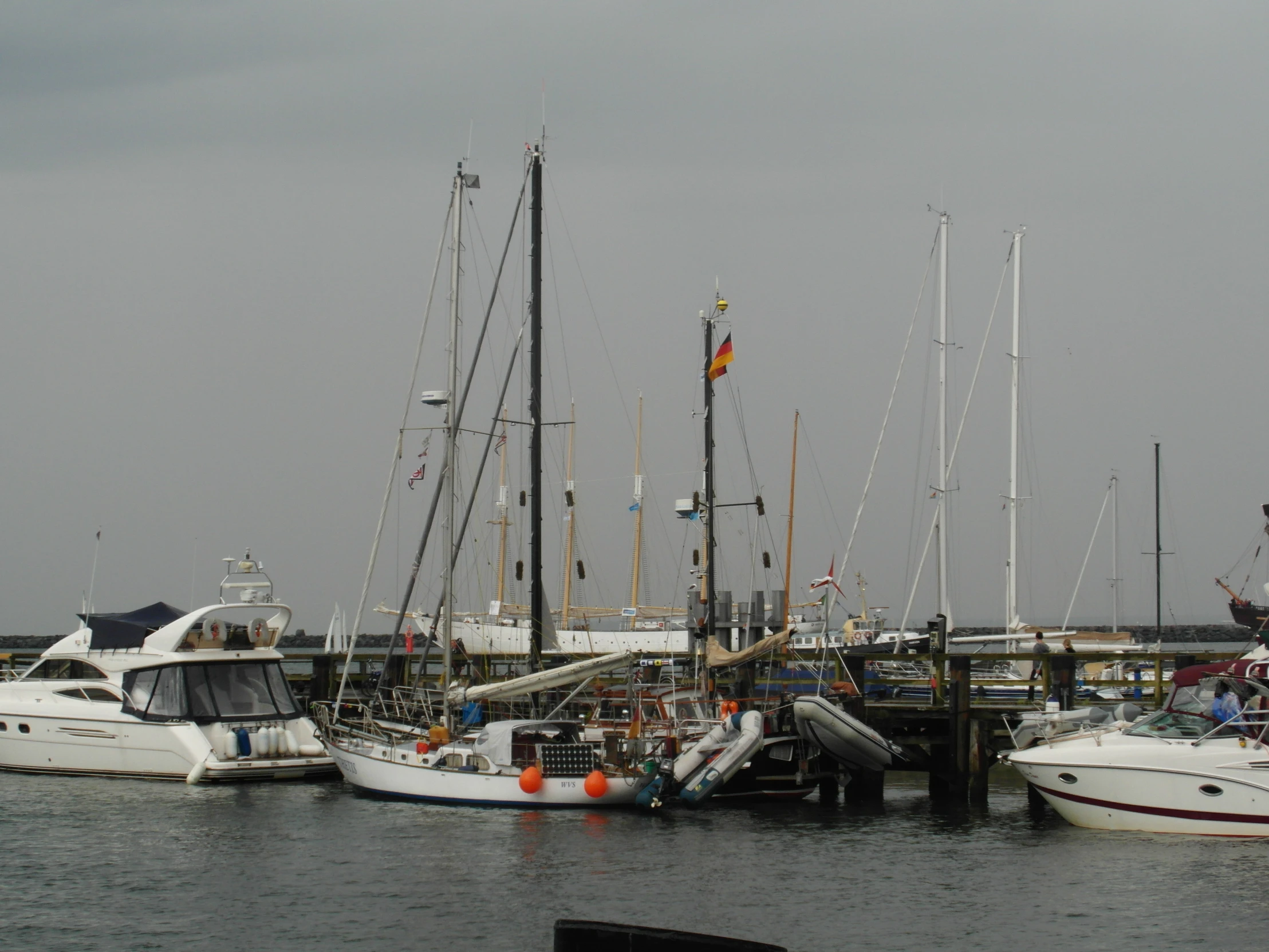 a group of boats parked in the water at a marina