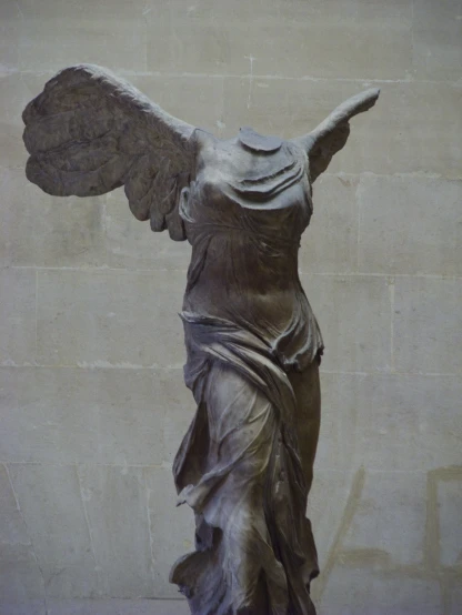 a stone sculpture of an angel on display