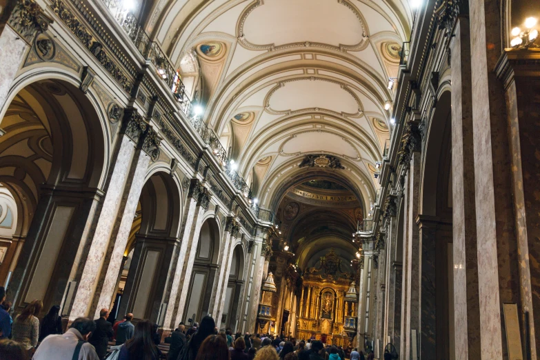 a cathedral with vaulted ceiling filled with people