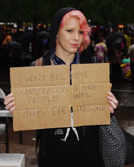 a woman is holding signs in her hands