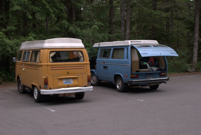 an older van and a smaller van parked side by side