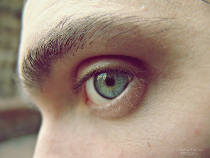 an eye with brown hair and blue eyes